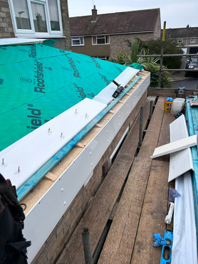 Flat roof converted to pitched tile roof.  Project image