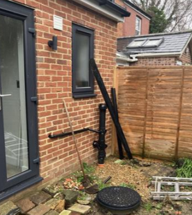 Single storey extension at the back of a end of terrace house with a flat roof. Project image