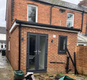 Single storey extension at the back of a end of terrace house with a flat roof. Project image