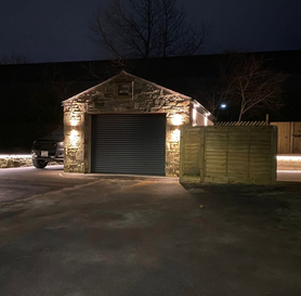 Garage and extension, with feature lighting installed on sleeper wall and stone wall Project image