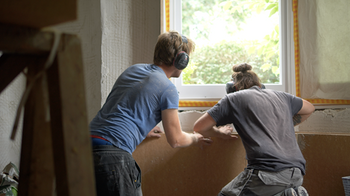Image of builders installing insulation
