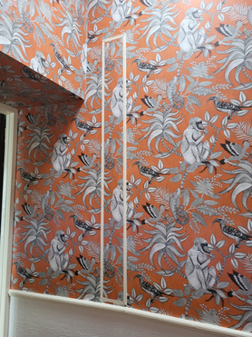 Hanging wallpaper in hallway and stairs area. Project image