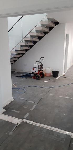 Taping and skimming around new stairs. Project image