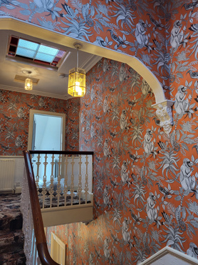 Hanging wallpaper in hallway and stairs area. Project image