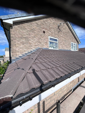 Flat roof converted to pitched tile roof.  Project image